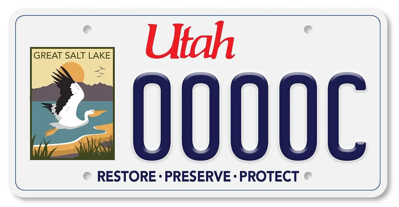 Great Salt Lake License Plate, image of a crane over the salt lake and mountains in the background. The words Restore - Preserve - Protect across the bottom of the license.