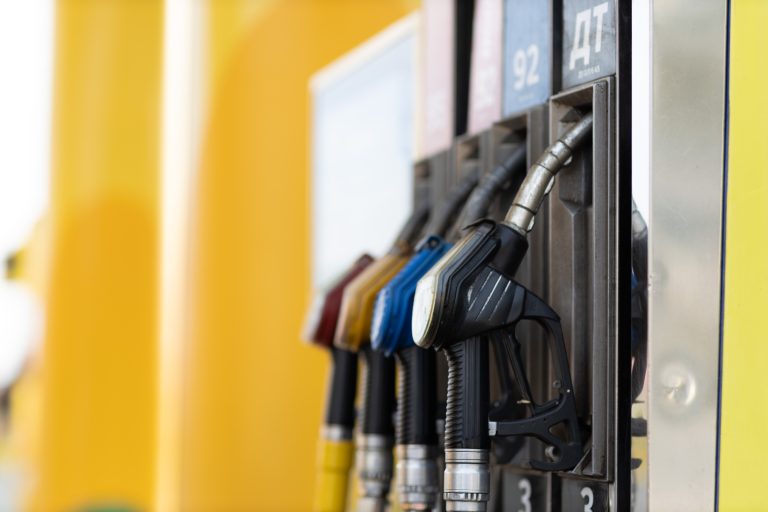 Close up filling gun in his hand at gas station.